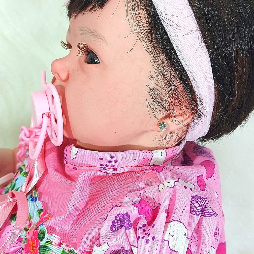 Mão de menina segurando o secador de cabelo.