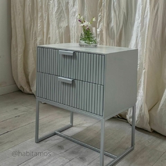 Vista lateral del mueble para dormitorio, que presenta dos cajones, todo en color gris con baño de poliuretano.