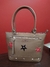 CARTERA CON ESTRELLAS Y NIQUEL.
