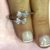 Anillo de Plata Cruzado con Moños y Cubic