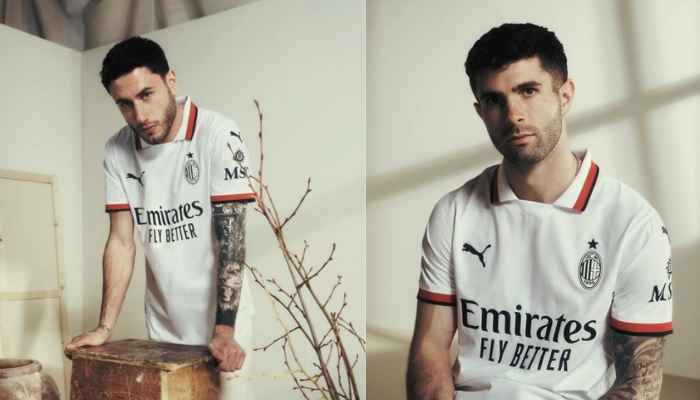 nova camisa reserva do AC Milan para a temporada 2024/25. A camisa branca possui um padrão tonal discreto, gola polo com detalhes em vermelho e preto, escudo do clube em linhas pretas e um selo especial celebrando os 125 anos do Milan.