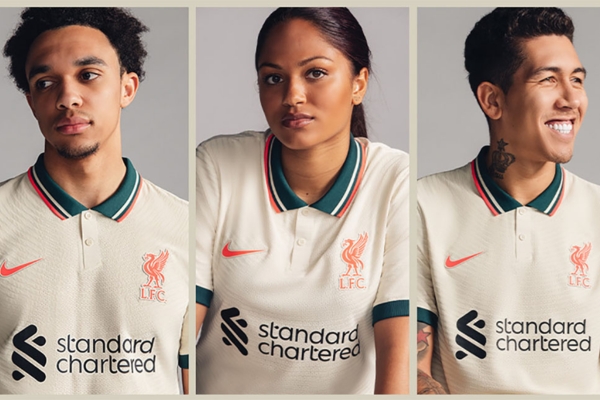 Camisa Reserva Liverpool Nike 2021/22 em tons marfim, verde e vermelho, gola polo, detalhes azul petróleo e laranja, símbolos icônicos Liver Bird e Swoosh. 10% OFF na 1ª compra + frete grátis!