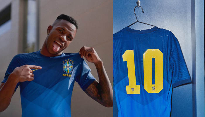 Camisa Retrô Reserva da Seleção Brasileira Nike 2020-2021 em azul escuro com detalhes em amarelo. A camisa apresenta um design com losangos em degradê e gola redonda com recorte na nuca. O escudo da CBF está bordado no lado esquerdo do peito e o logo da Nike em amarelo no lado direito. A numeração nas costas é inspirada na Copa do Mundo de 70.