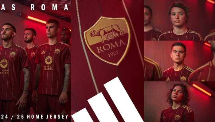 Camisa titular da AS Roma para a temporada 2024-2025. A camisa é predominantemente vermelha com finas linhas verticais em amarelo e grená. O escudo da Roma está no lado esquerdo do peito em vermelho e amarelo. O logo da Adidas está no lado direito do peito em amarelo. A gola é redonda e as mangas têm as três listras da Adidas em amarelo.