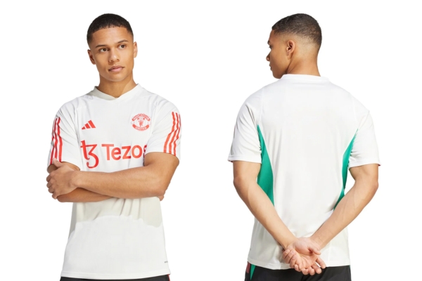 Camisa de Treino Manchester United Adidas 2023-2024: Base branca, detalhes em verde e vermelho, inspirada no modelo Adidas Tiro 23. Conforto e estilo premium para seus treinos.