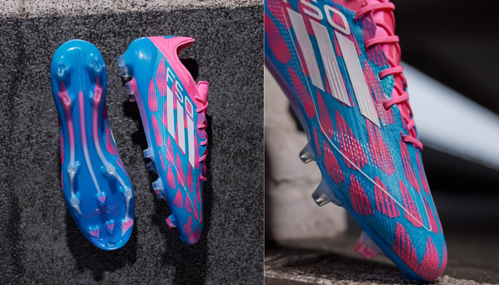 Chuteira de futebol Adidas F50 Elite FG em destaque, apresentando cabedal azul com detalhes em rosa, design moderno e tecnológico, ideal para jogadores que buscam velocidade e performance máxima em campo.