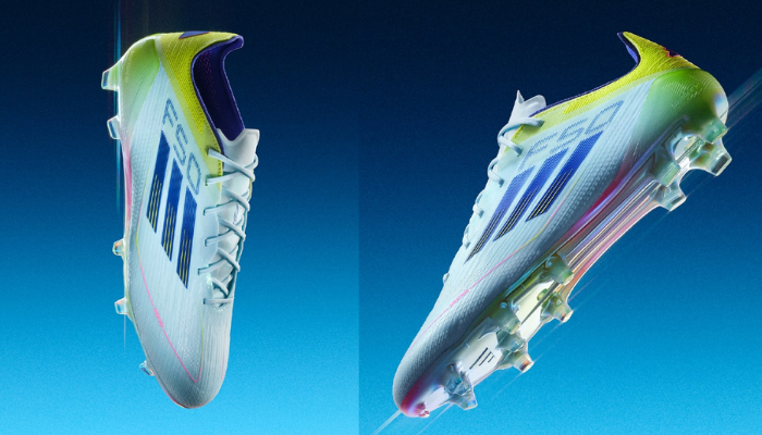 Chuteiras de futebol Adidas F50 Elite FG Stellar Icon em cor azul com detalhes em amarelo, rosa e azul. As chuteiras possuem um design moderno e elegante, com uma sola iridescente e tecnologia avançada para proporcionar velocidade máxima e controle preciso da bola.