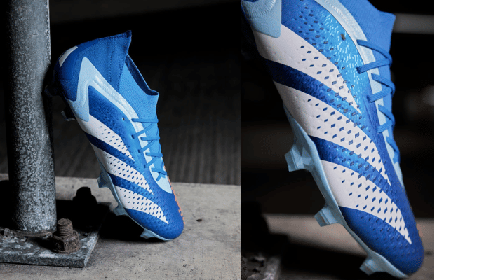 Chuteira Adidas Predator Accuracy.1 FG Marine Rush Azul, branca e vermelha. A parte superior da chuteira é azul com detalhes em branco e vermelho. A sola da chuteira é preta com travas brancas.