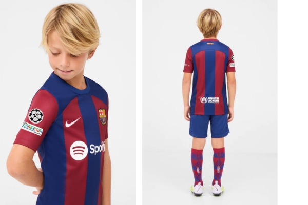 Kit Infantil do Barcelona Nike 2023/24 Azul e grená - Camisas listradas em azul e grená, escudo com relevo de diamante, calção azul e meiões vermelhos com detalhes em azul. Celebre a história no Camp Nou!