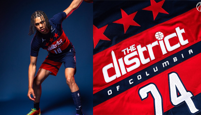 Torcedor do Washington Wizards usando a nova regata Statement Edition 2024-25 da Jordan Brand. A regata apresenta as cores do time, a frase "The District of Columbia" e o logo da Jordan.