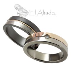 1123. Argollas en Titanio con oro rosado 18k.