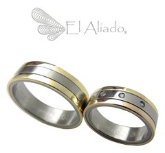 1128. Argollas en Titanio con biseles en oro rosado y amarillo 18k.