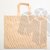 Bolsa friselina con manijas tiras