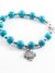 Pulsera con piedra celeste y dije cruz san benito acero