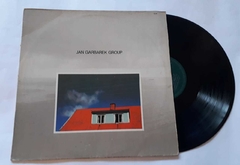 JAN GARBARECK GROUP - PHOTO WITH BLUE SKY, WHITE CLOUD, WIRES, WINDOWS AND RED ROOF